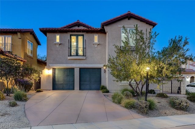 mediterranean / spanish house featuring a garage