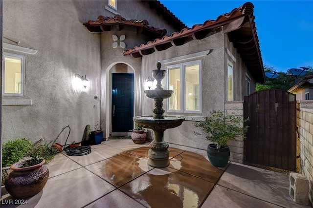 entrance to property featuring a patio