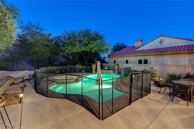 view of swimming pool with an in ground hot tub and a patio area