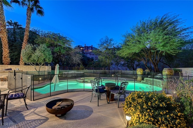 view of swimming pool with a fire pit and a patio