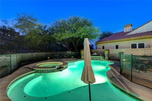 view of swimming pool with an in ground hot tub