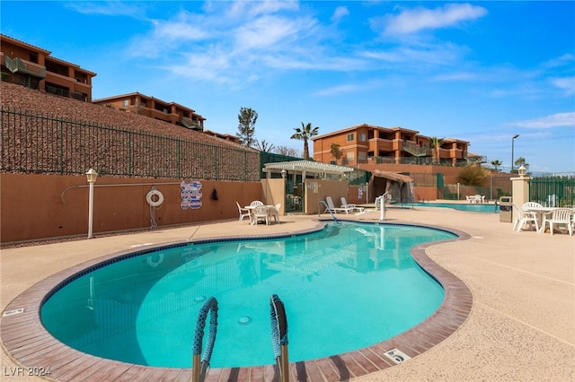 view of swimming pool with a patio