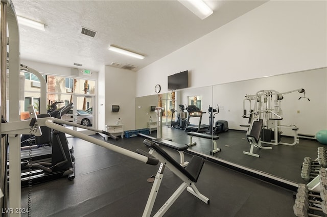 workout area featuring a textured ceiling