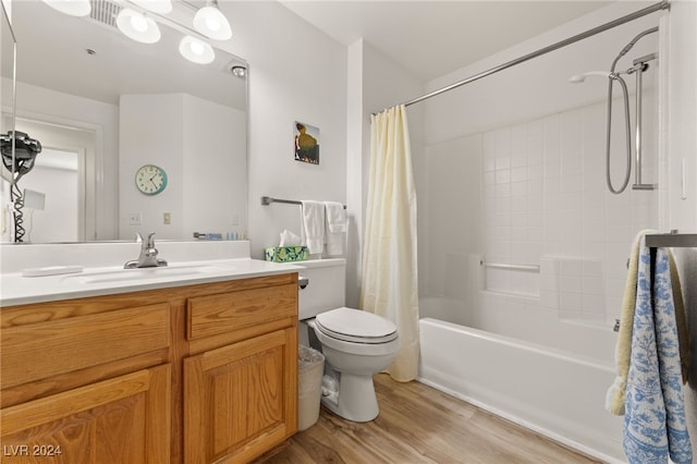 full bathroom featuring vanity, toilet, hardwood / wood-style flooring, and shower / tub combo with curtain