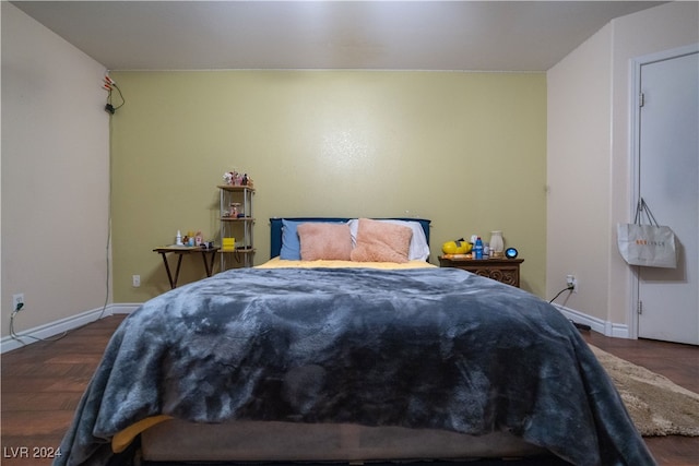 bedroom with dark hardwood / wood-style flooring