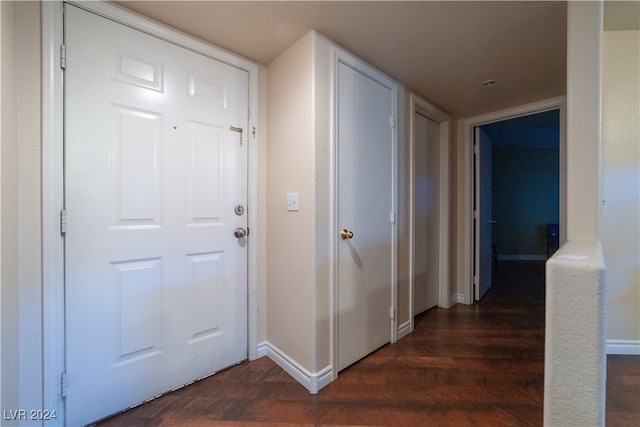 corridor featuring dark wood-type flooring