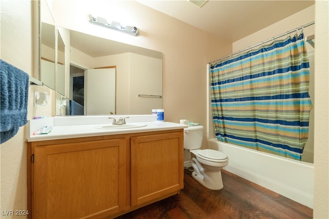 full bathroom with vanity, toilet, hardwood / wood-style flooring, and shower / bathtub combination with curtain