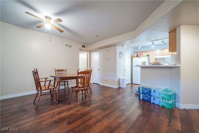 dining space with ceiling fan, dark hardwood / wood-style floors, and track lighting