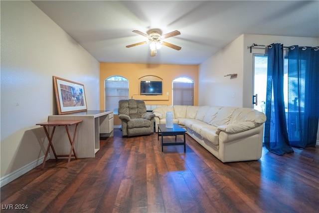 living room featuring dark hardwood / wood-style flooring and ceiling fan