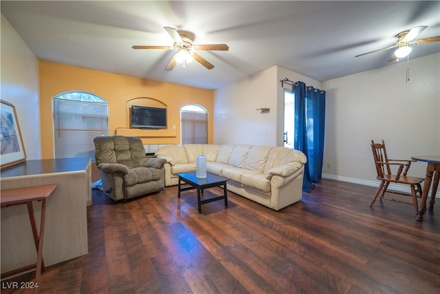 living room featuring dark wood-type flooring, a healthy amount of sunlight, and ceiling fan