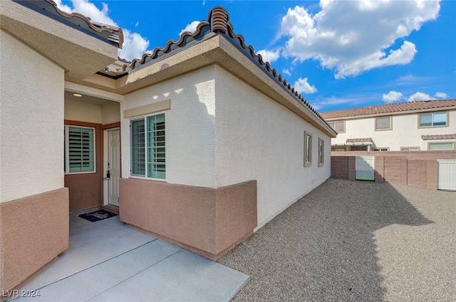 view of side of property with a patio area