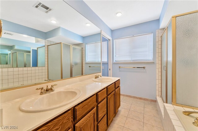 bathroom featuring vanity, tile patterned floors, and plus walk in shower