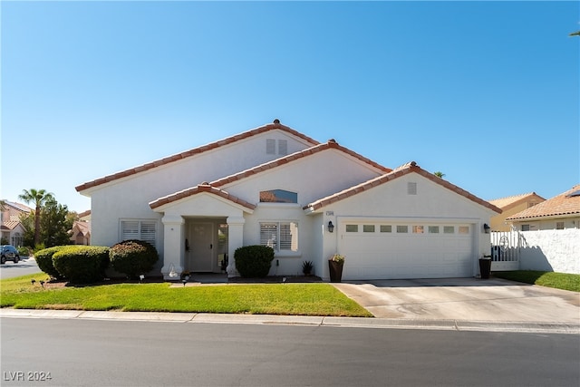 mediterranean / spanish-style home with a garage