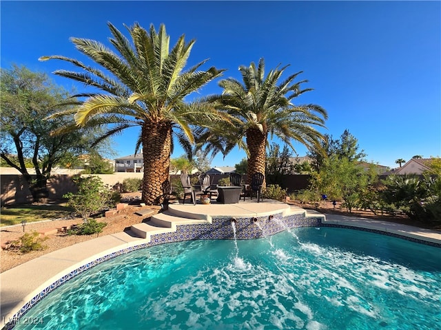 view of pool featuring pool water feature and a patio area