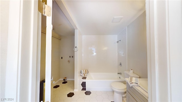 bathroom featuring toilet and tiled shower / bath