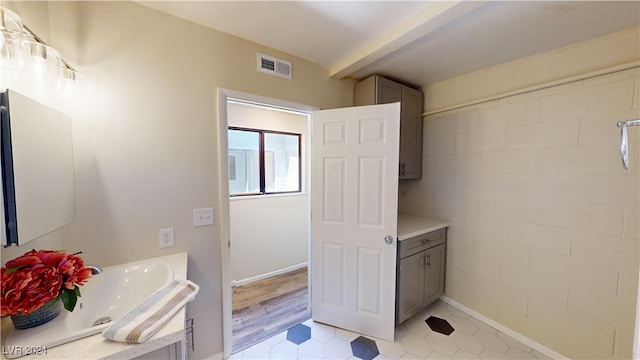 bathroom with a tub to relax in, vanity, and hardwood / wood-style floors