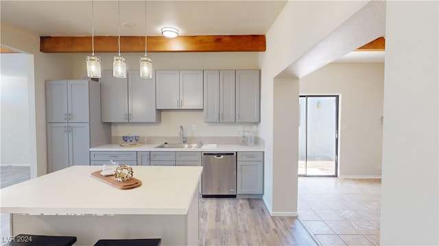 kitchen featuring pendant lighting, beam ceiling, sink, and stainless steel dishwasher