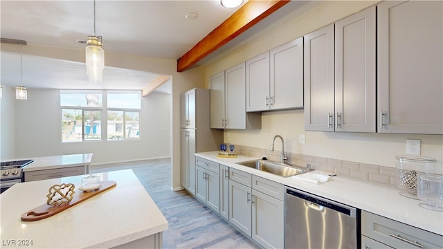 kitchen with gray cabinetry, light wood-type flooring, decorative light fixtures, sink, and stainless steel dishwasher