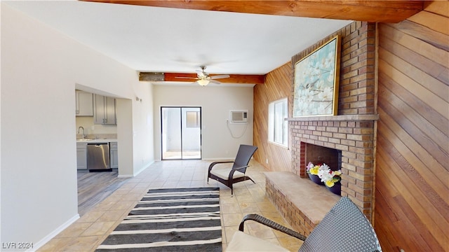 tiled living room featuring a wall mounted AC, a brick fireplace, wood walls, and ceiling fan