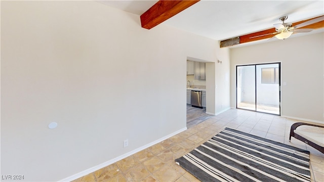 unfurnished living room with ceiling fan, beam ceiling, and sink