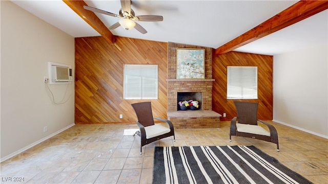 living area featuring wooden walls, ceiling fan, a wall mounted air conditioner, and a fireplace