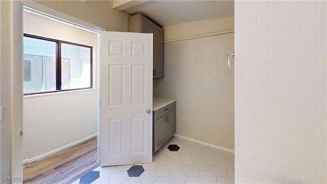 bathroom with a shower and wood-type flooring