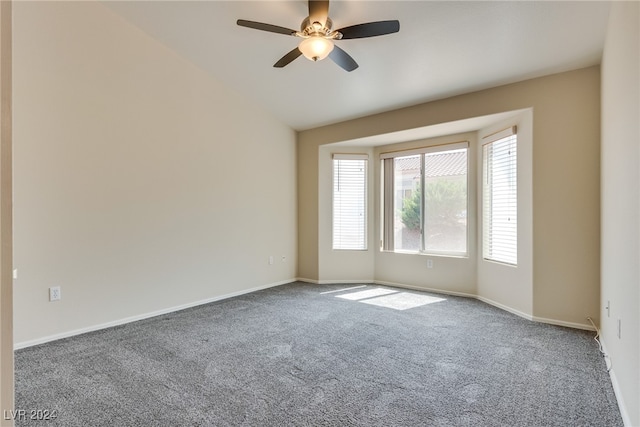 carpeted spare room with lofted ceiling and ceiling fan