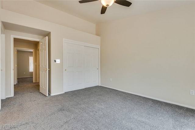 unfurnished bedroom with a closet, ceiling fan, and carpet floors