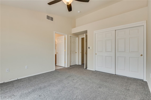 unfurnished bedroom featuring light colored carpet, ceiling fan, and a closet