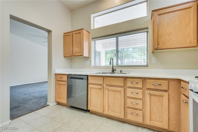 kitchen with dishwasher, light tile patterned floors, light brown cabinetry, and sink