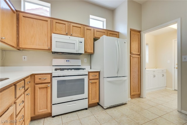 kitchen with light tile patterned floors and white appliances