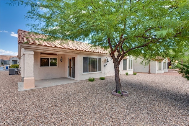 rear view of house with a patio area and cooling unit