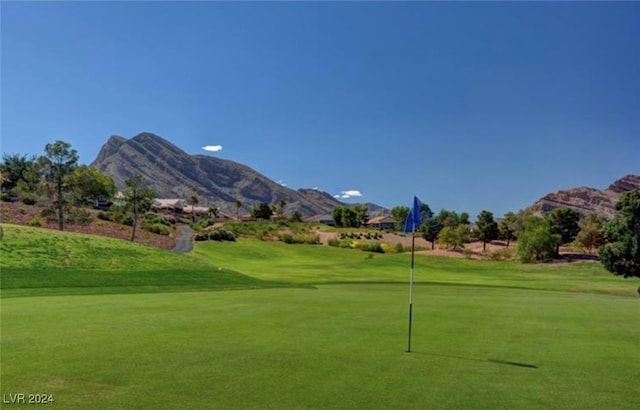 view of community with a lawn and a mountain view