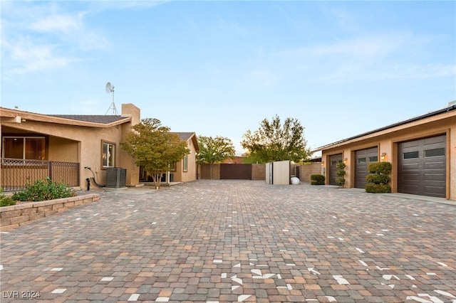 view of side of home with central AC and a garage