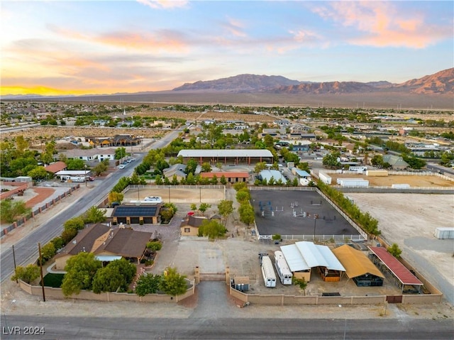 aerial view at dusk featuring a mountain view