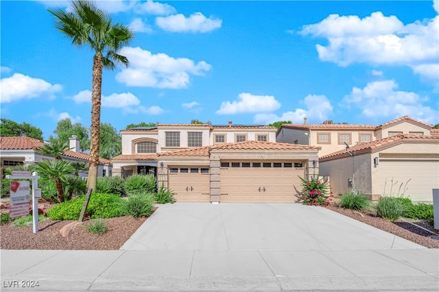 mediterranean / spanish house with a garage