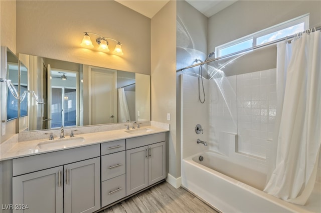 bathroom with shower / bathtub combination with curtain, hardwood / wood-style flooring, and vanity