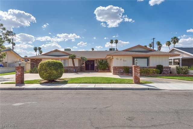 ranch-style home with brick siding and concrete driveway