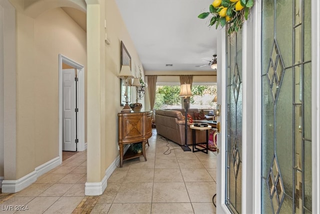 interior space with ceiling fan and light tile patterned floors