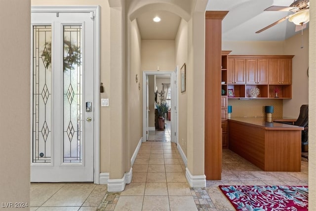 tiled foyer with ceiling fan