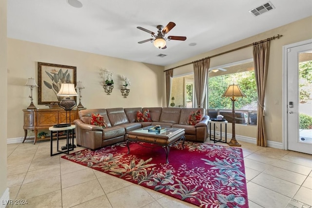 tiled living room featuring ceiling fan and a healthy amount of sunlight