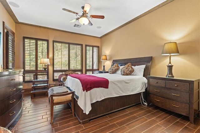 bedroom featuring crown molding, ceiling fan, and dark hardwood / wood-style floors