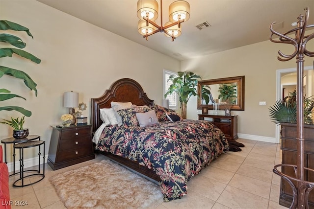 bedroom with a chandelier and light tile patterned floors