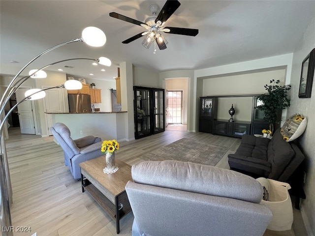 living room with ceiling fan and light hardwood / wood-style floors