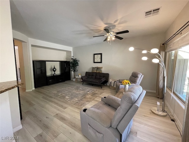 living room with ceiling fan and light hardwood / wood-style floors