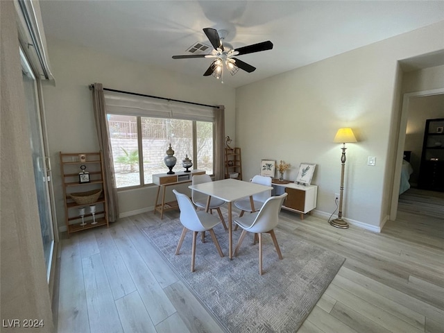 dining space with light hardwood / wood-style flooring and ceiling fan