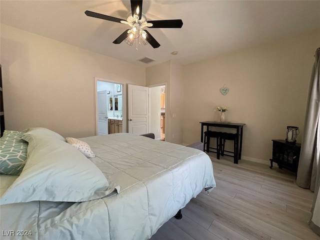 bedroom with ceiling fan, connected bathroom, and light hardwood / wood-style floors