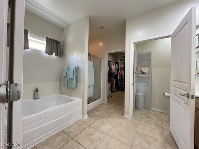 bathroom with vanity, tile patterned floors, and plus walk in shower