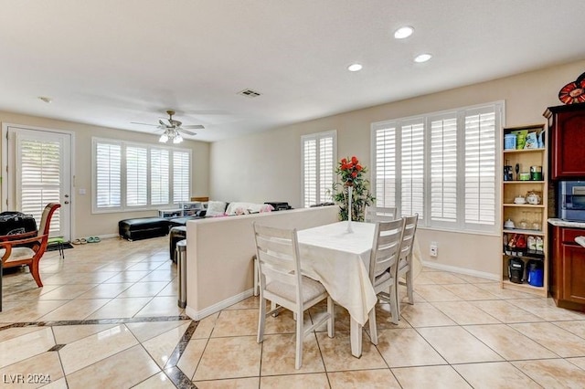 dining space featuring ceiling fan and light tile patterned floors