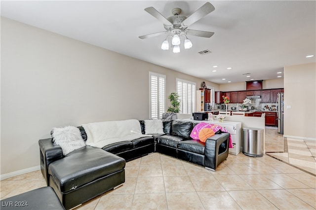 tiled living room with ceiling fan